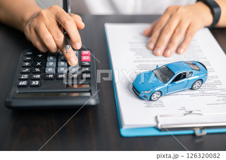 Finance bank tax expense accounting budget money businessman hand for Business expense analysis saving use car Financial calculate accountant close up calculator with graph chart write office desk 126320082
