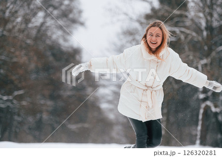 Beautiful happy woman is enjoying walk outdoors at winter time 126320281