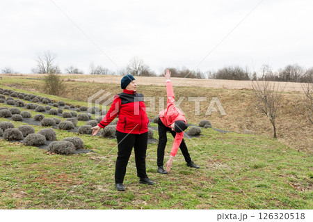 Enjoying a spirited outdoor yoga session among the lush lavender fields in early spring, embracing nature and wellness in harmony with the environment Enjoying a spirited outdoor yoga session among the lush lavender fields in early spring, embracing nature and wellness in harmony with the environment 126320518