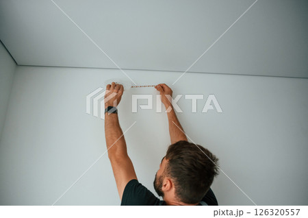 Man is working with lighting equipment indoors at domestic room Man is working with lighting equipment indoors at domestic room 126320557