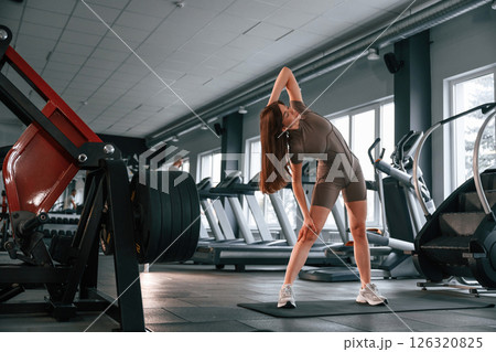 On the yoga mat. Beautiful woman with sport body type is in the gym On the yoga mat. Beautiful woman with sport body type is in the gym 126320825