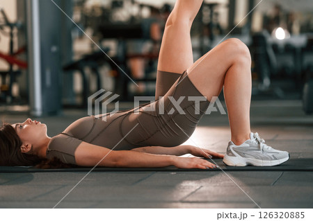 Fitness exercises. Beautiful woman with sport body type is in the gym 126320885