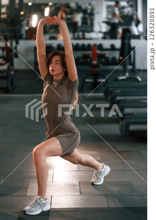 Legs exercises. Beautiful woman with sport body type is in the gym Legs exercises. Beautiful woman with sport body type is in the gym 126320891