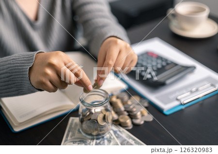 Finance bank tax expense accounting budget money businessman hand use calculator Financial calculate accountant close up calculator with graph chart write office desk Business expense analysis saving 126320983