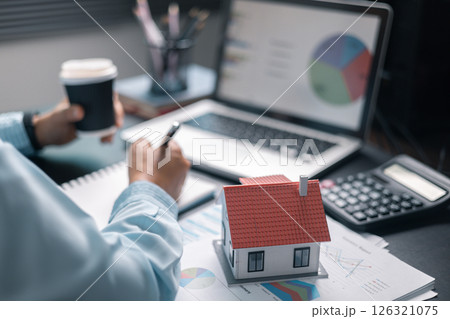 Finance bank tax expense accounting budget money businessman home for Business expense analysis saving use Financial calculate accountant close up calculator with graph chart hand write office desk 126321075