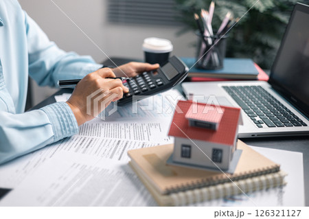 Finance bank tax expense accounting budget money businessman home for Business expense analysis saving use Financial calculate accountant close up calculator with graph chart hand write office desk 126321127