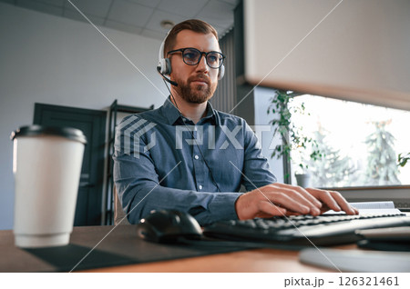 Typing on the keyboard. Man in formal clothes is working in the modern office. Using computer 126321461