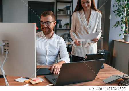 Designers are talking and working. Two employees are together in the modern office 126321895