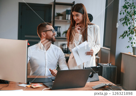 Designers are talking and working. Two employees are together in the modern office 126321898