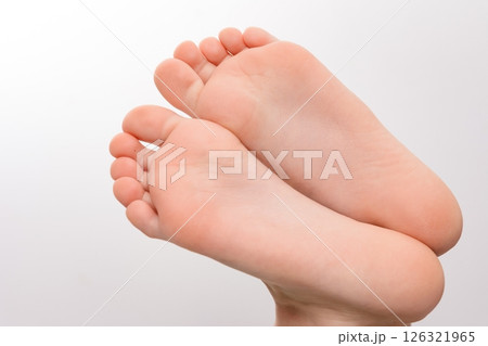 Close-up of two small, clean feet soles against a white background. Close-up of two small, clean feet soles against a white background. 126321965
