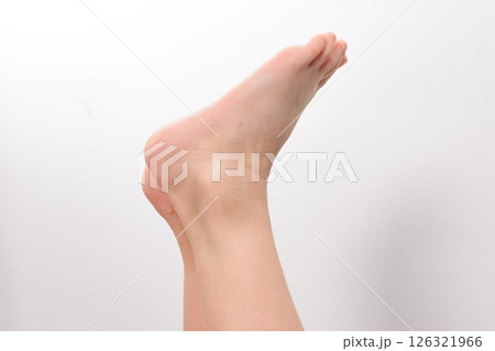 Close-up of a human foot and ankle against a white background. Close-up of a human foot and ankle against a white background. 126321966