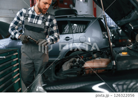 Man in uniform is working in the auto salon 126322056