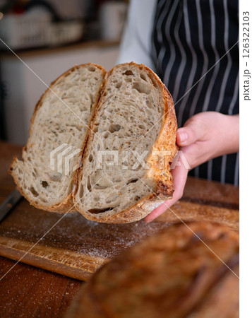Artisan Sourdough Bread in Hand - Fresh from the Oven. Artisan Sourdough Bread in Hand - Fresh from the Oven. 126322103