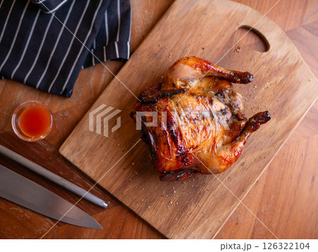 Whole Grilled Chicken on Wooden Table. 126322104