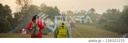 Couple traveler with backpack hiking outdoor travel lifestyle and adventure concept. cap backpack and join of tourist for green mountain tour, beauty of nature and expansive sky people of tourism Couple traveler with backpack hiking outdoor travel lifestyle and adventure concept. cap backpack and join of tourist for green mountain tour, beauty of nature and expansive sky people of tourism 126322155