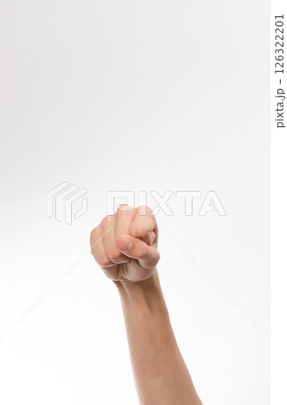 Close-up of a hand forming a fist against a white background. A simple, clean image ideal for various design projects. 126322201