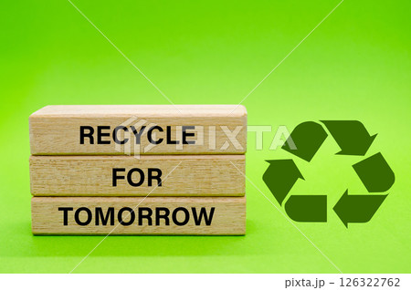 Recycle symbol with wooden blocks with text Recycle For Tomorrow on a green background. Promoting reuse, reduce, and recycle for sustainability 126322762