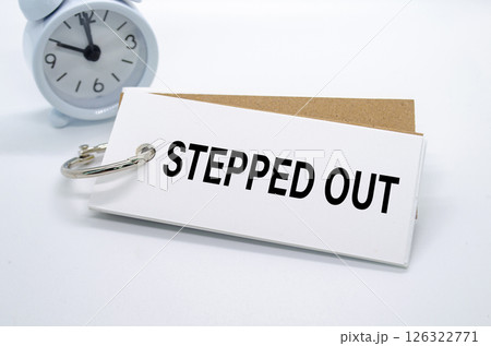 Stepped Out text on white notepad with alarm clock on white background. Away from office concept 126322771