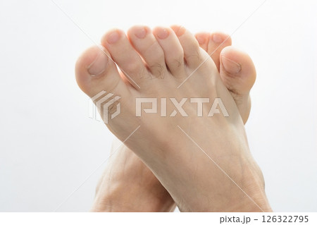 Close-up of human feet against a white background. Close-up of human feet against a white background. 126322795