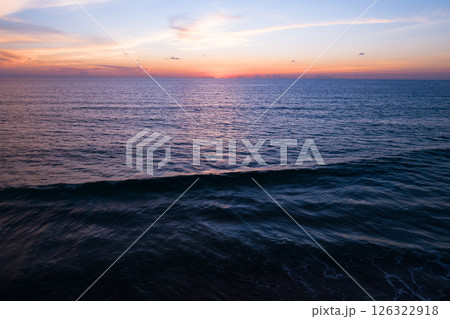 Aerial view sunset sky,Nature beautiful light sunset or sunrise over sea,Colorful dramatic majestic scenery sunset Sky with Amazing clouds and waves texture colorful sky cloud background 126322918