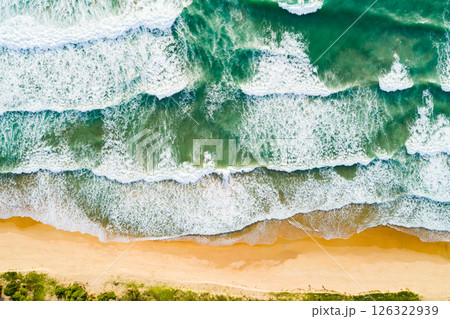 Aerial view Waves crashing on sandy shore,Sea surface in summer day background,Seascape top view waves texture background 126322939