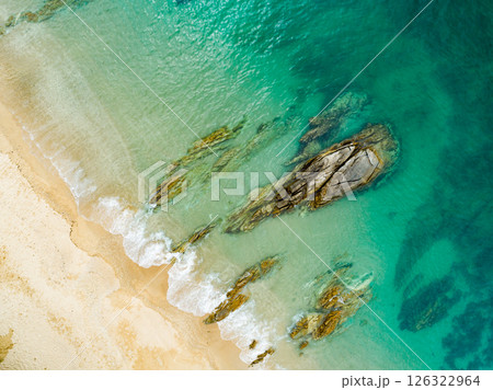 Aerial view Waves crashing on sandy shore,Sea surface in summer day background,Seascape top view waves texture background 126322964