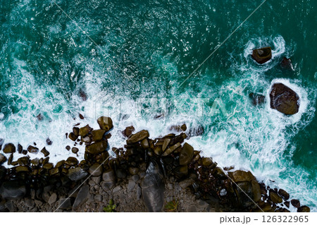 Aerial view Top down seashore, Waves crashing on rocks cliff, Beautiful sea surface in sunny day summer background, Amazing seascape top view seacoast at Phuket Thailand Aerial view Top down seashore, Waves crashing on rocks cliff, Beautiful sea surface in sunny day summer background, Amazing seascape top view seacoast at Phuket Thailand 126322965