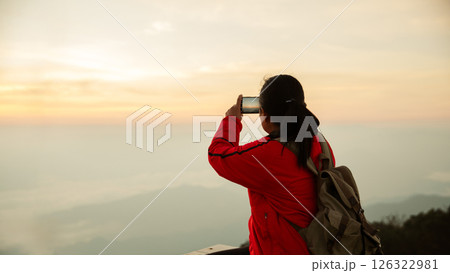 Woman traveler with backpack hiking outdoor travel lifestyle and adventure concept. cap backpack and join of tourist for green mountain tour, beauty of nature and expansive sky people of tourism Woman traveler with backpack hiking outdoor travel lifestyle and adventure concept. cap backpack and join of tourist for green mountain tour, beauty of nature and expansive sky people of tourism 126322981