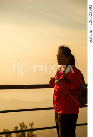 Woman traveler with backpack hiking outdoor travel lifestyle and adventure concept. cap backpack and join of tourist for green mountain tour, beauty of nature and expansive sky people of tourism Woman traveler with backpack hiking outdoor travel lifestyle and adventure concept. cap backpack and join of tourist for green mountain tour, beauty of nature and expansive sky people of tourism 126322992