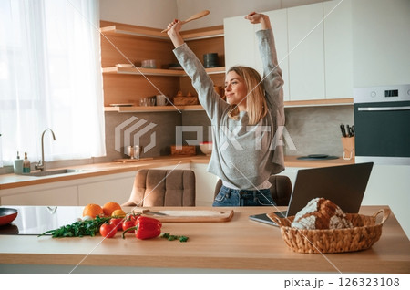 Morning stretching. Beautiful young woman is on the kitchen 126323108