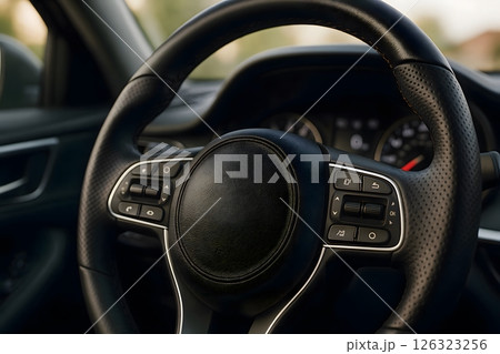 Closeup of modern car steering wheel with control buttons and leather texture 126323256