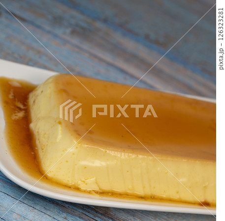 Cream caramel pudding with caramel sauce on a plate, Flan 126323281