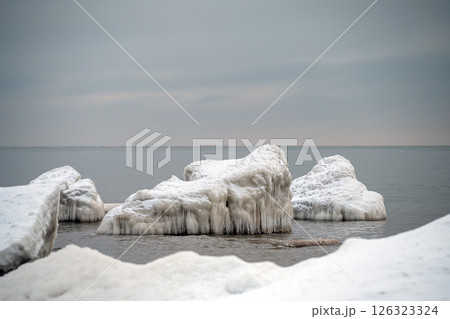 Close-up shot of the Frozen ice blocks in Baltic sea water on the shore, Kaltene, Latvia 126323324