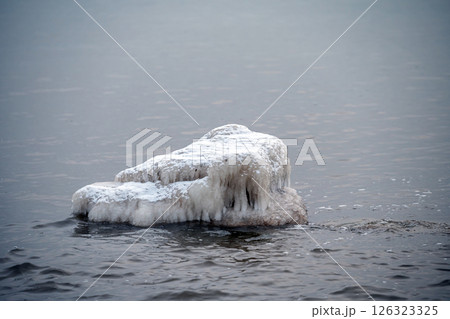 Close-up shot of the Frozen ice blocks in Baltic sea water on the shore, Kaltene, Latvia Close-up shot of the Frozen ice blocks in Baltic sea water on the shore, Kaltene, Latvia 126323325