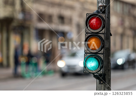 closeup of small traffic semaphore with green light against the backdrop of the city traffic closeup of small traffic semaphore with green light against the backdrop of the city traffic 126323855