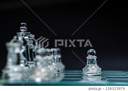 transparent glass chess on dark background, selective focus on pawn piece, closeup 126323974