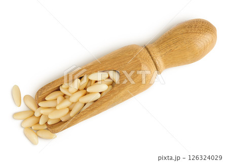 Shelled European pine nuts in wooden scoop isolated on white background with full depth of field. Top view. Flat lay 126324029