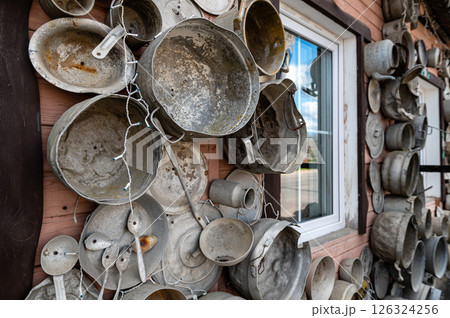 The pan house (puodu namas) is covered with pots and pans of all shapes and sizes, closeup view The pan house (puodu namas) is covered with pots and pans of all shapes and sizes, closeup view 126324256