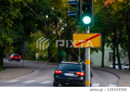 traffic semaphore with green light on defocused background of autumn city, closeup traffic semaphore with green light on defocused background of autumn city, closeup 126324500