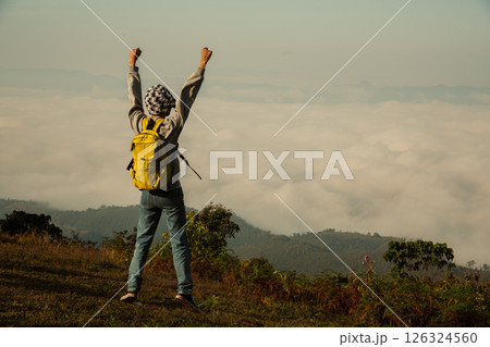 Man traveler with camera backpack hiking outdoor travel lifestyle and adventure concept. cap backpack and join of tourist for green mountain tour, beauty of nature and expansive sky people of tourism 126324560