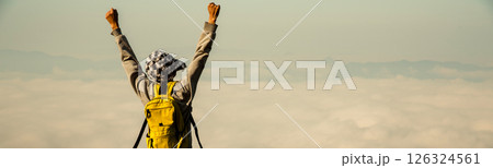Man traveler with backpack hiking outdoor travel lifestyle and adventure concept. join of tourist for green mountain tour beauty of nature and expansive sky people of tourism. banner with copy space Man traveler with backpack hiking outdoor travel lifestyle and adventure concept. join of tourist for green mountain tour beauty of nature and expansive sky people of tourism. banner with copy space 126324561