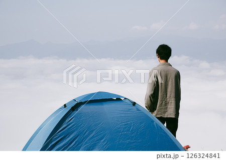 Man traveler with camera backpack hiking outdoor travel lifestyle and adventure concept. cap backpack and join of tourist for green mountain tour, beauty of nature and expansive sky people of tourism 126324841
