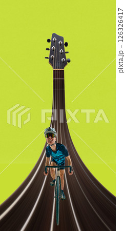 Sporty man in full gear rides bicycle over surreal guitar string path on lime background. Stretch effect. 126326417