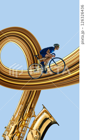 Male cyclist rides over looping golden trail formed from saxophone bell against blue background. Stretch effect. 126326436