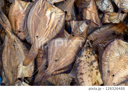 Dried fish on display at a lively market, highlighting local seafood preservation for sale. 126326488