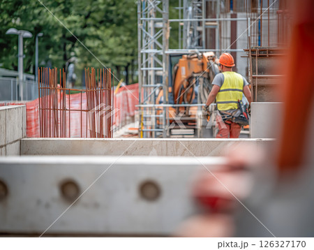 Construction Site Activity with Workers in Safety Gear Overseeing Structural Progress 126327170