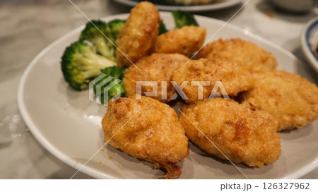 close up of Cantonese dish deep fried tofu ( bean curd) coated with salty egg york close up of Cantonese dish deep fried tofu ( bean curd) coated with salty egg york 126327962
