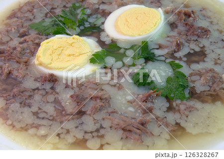 aspic with meat, eggs and fresh parsley, made with thick and rich nutritious bone broth, frozen. closeup 126328267
