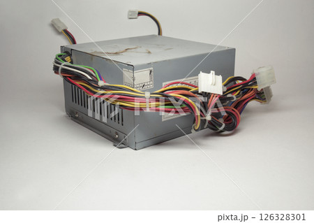 computer ATX power supply unit front side with ventilation openings. colorful power cords for conneting to drives directly from non-modular case computer ATX power supply unit front side with ventilation openings. colorful power cords for conneting to drives directly from non-modular case 126328301