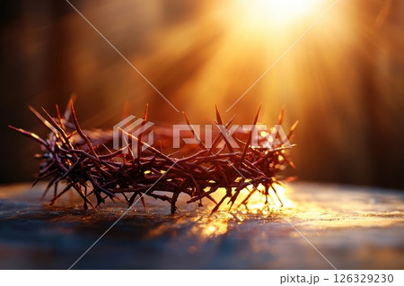 Crown of thorns on table top, a glowing chist cross in church background. Crown of thorns on table top, a glowing chist cross in church background. 126329230